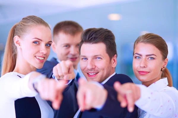 Group of business people pointing to you