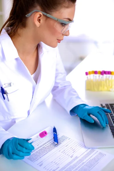 Woman researcher is surrounded by medical vials and flasks, isolated on white background