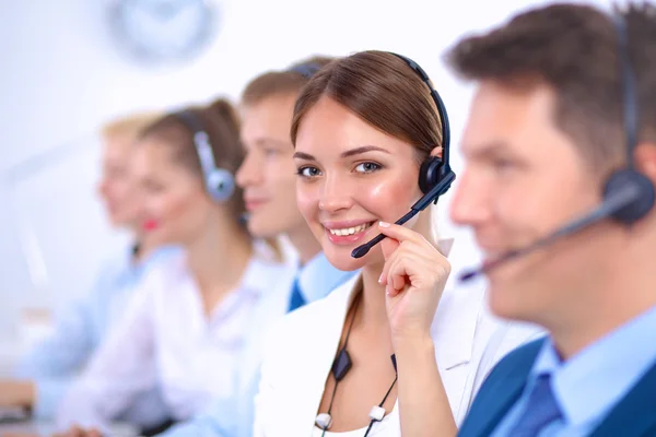 Attractive Smiling positive young businesspeople and colleagues in a call center office