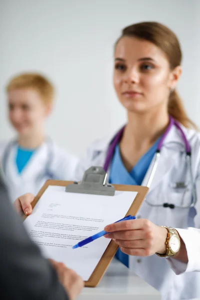 Medical team sitting at the table in modern hospital