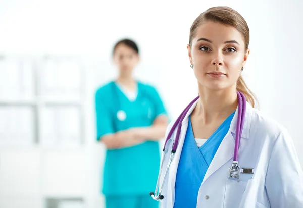 Attractive female doctor in front of medical group