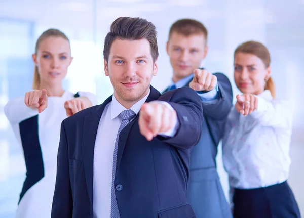 Group of business people pointing to you