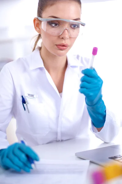 Woman researcher is surrounded by medical vials and flasks, isolated on white background