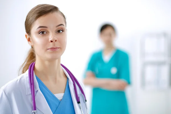 Attractive female doctor in front of medical group