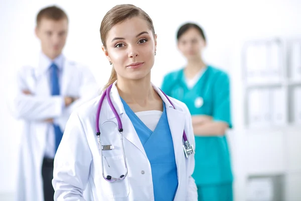 Attractive female doctor in front of medical group