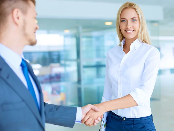 Two successful business people shaking hands with each other