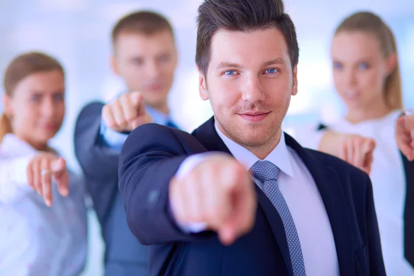 Group of business people pointing to you