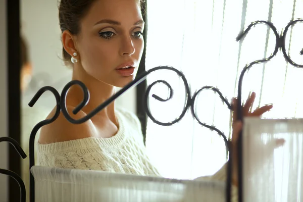 Portrait of a cute woman in sweater at home