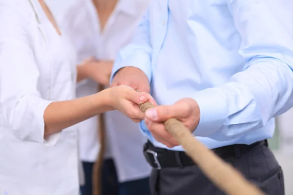 Concept image of business team using a rope as an element  the teamwork on foreground