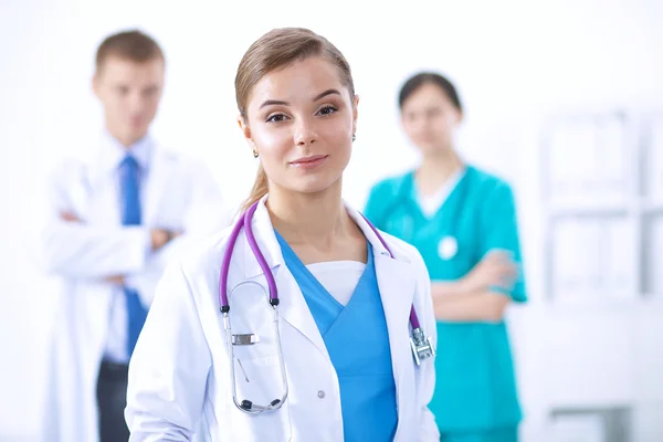 Attractive female doctor in front of medical group