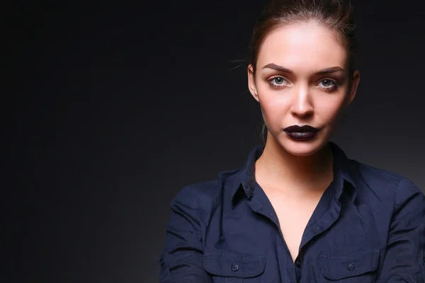 Portrait of beautiful young woman face. Isolated on black background