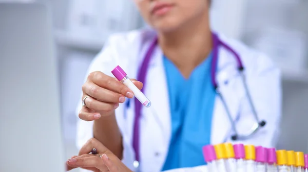 Woman researcher is surrounded by medical vials and flasks, isolated on white background