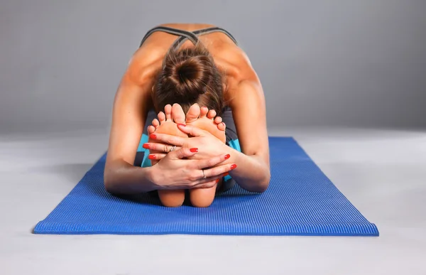 Portrait of sport girl doing yoga stretching exercise