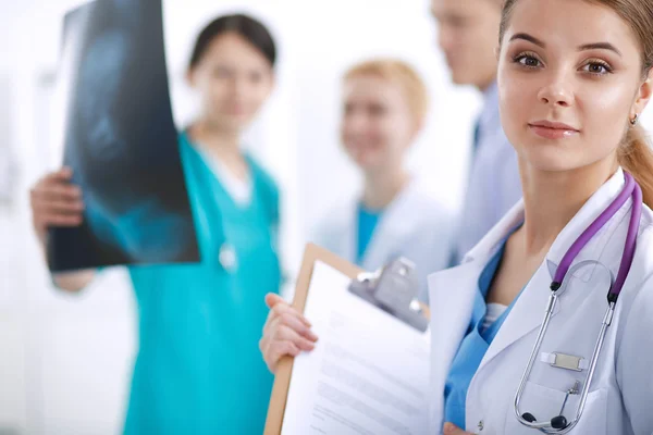 Attractive female doctor in front of medical group