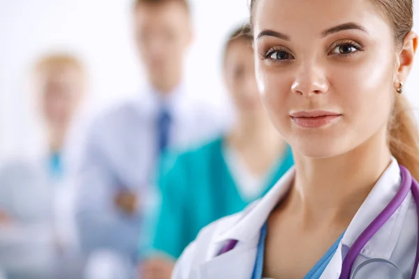 Attractive female doctor in front of medical group