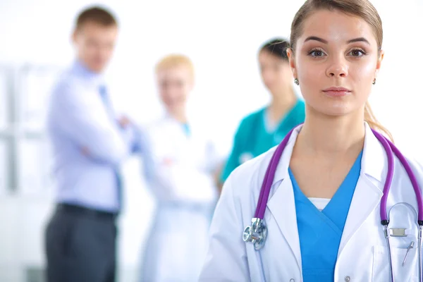 Attractive female doctor in front of medical group