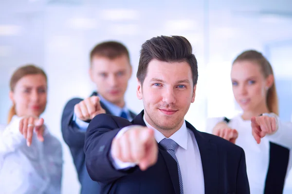 Group of business people pointing to you