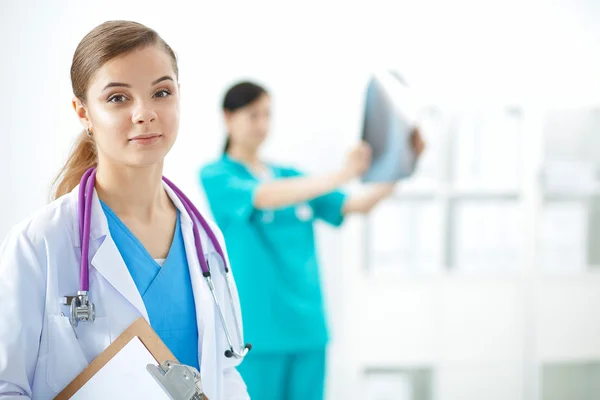 Attractive female doctor in front of medical group