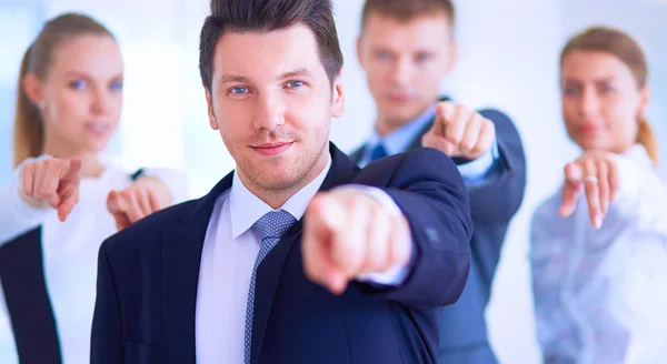 Group of business people pointing to you