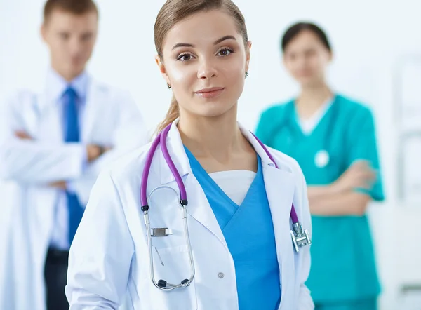 Attractive female doctor in front of medical group