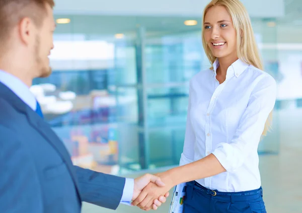 Two successful business people shaking hands with each other