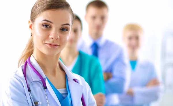 Attractive female doctor in front of medical group