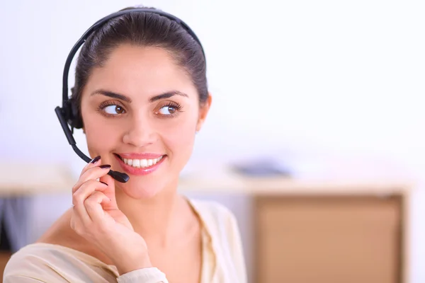 Close-up portrait of a customer service agent sitting at office