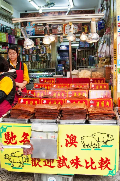 People at marketplace in Macao, selling traditional meat