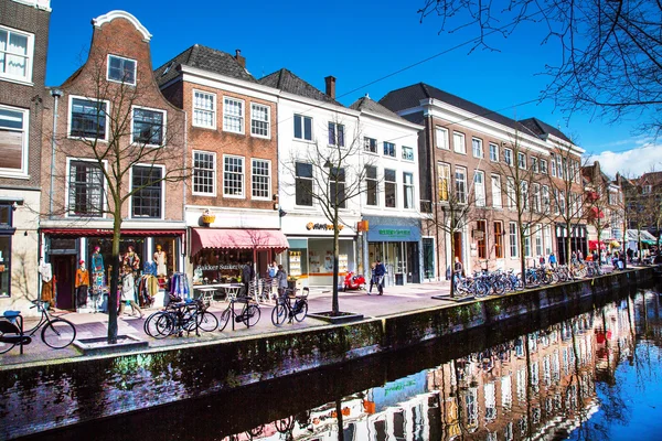 Colorful street view with houses and canal in Delft, Holland