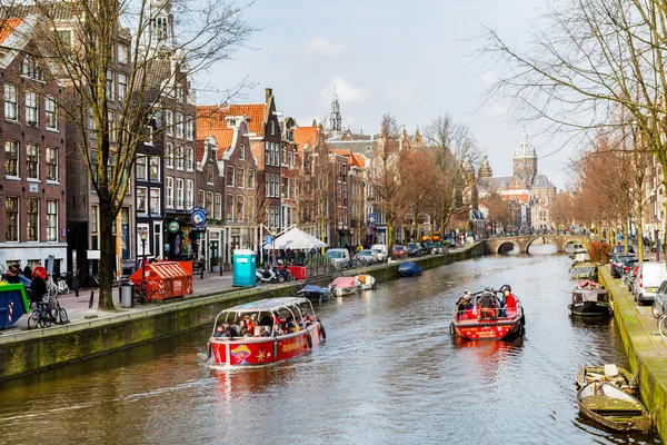 Cruise boat at Amsterdam canals in Holland, street view