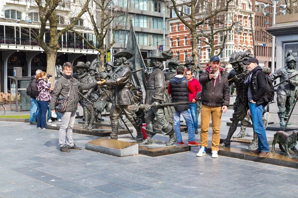 Tourists posing near Night Watch by Rembrandt in Rembrandtplein, Amsterdam