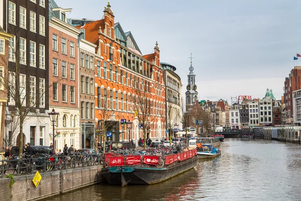 Boat, Munttoren Clock Tower and flower market in Amsterdam canal in Holland