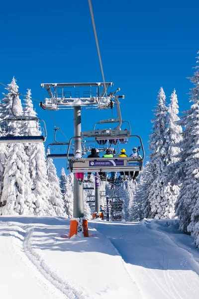 Ski resort Kopaonik, Serbia, ski lift, white snow pine trees, blue sky