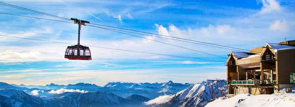 Winter sports travel background with cable car, mountain peaks