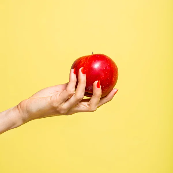 Hand holds apple. Raw food concept