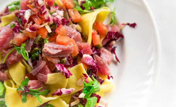 Homemade tagliatelle with fresh tuna served with cherry tomatoes