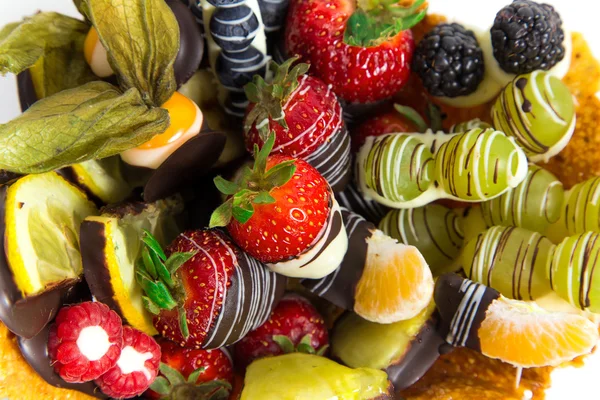 Fitness dessert: fruit salad covered with decorative chocolate