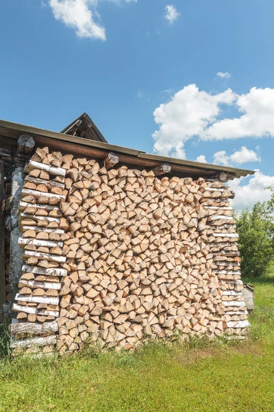 Stacked birch dry woods with crib end