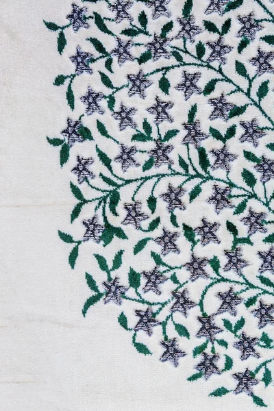 Fragment of colorful retro tapestry textile pattern with floral ornament