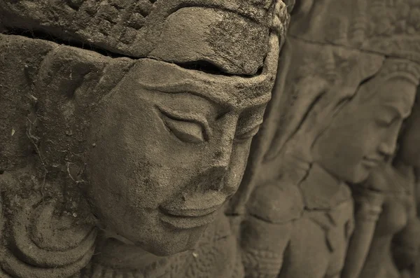 Sculpture of a broken nose in the ancient temples of Angkor Wat