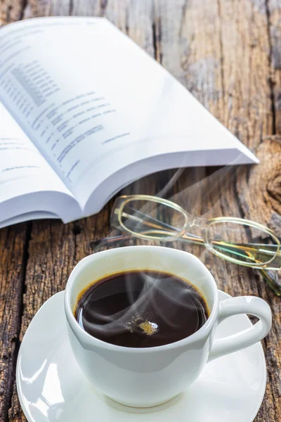 Coffee and book on wood table