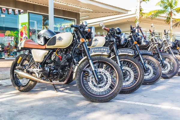 Vintage motorcycles parked in the parking lot