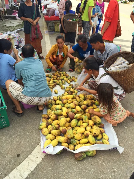 CHIANG RAI, THAILAND - AUGUST 9 : vertical photo of unidentified people buying mangoes in a market at the Thai-Laos frontier on August 9, 2016 in Chiang rai, Thailand. This is one of travel attraction in Chiang Rai.