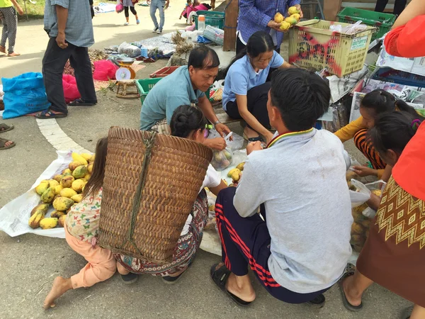 CHIANG RAI, THAILAND - AUGUST 9 : horizontal photo of unidentified people buying mangoes in a market at the Thai-Laos frontier on August 9, 2016 in Chiang rai, Thailand. This is one of travel attraction in Chiang Rai.
