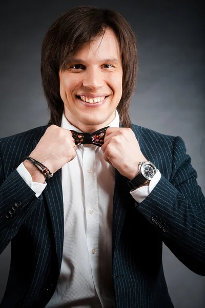 Handsome man with long hair brunette and brown eyes in dark suit