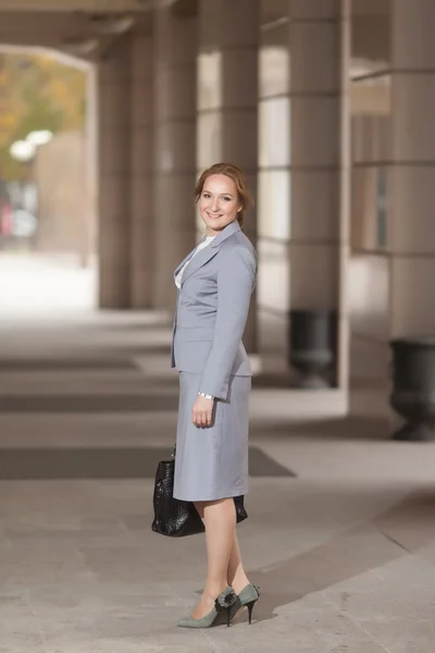 Red haired business women in grey suit