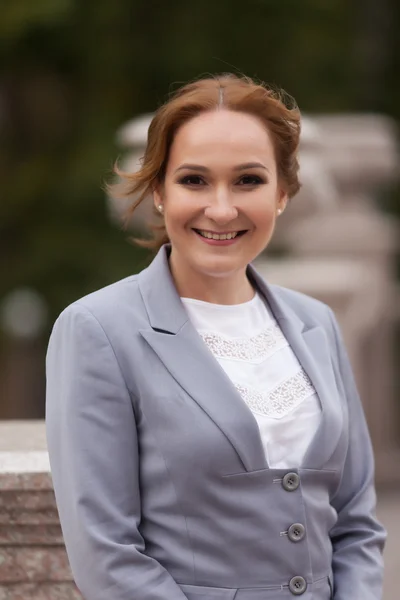 Smiling business women in grey suit
