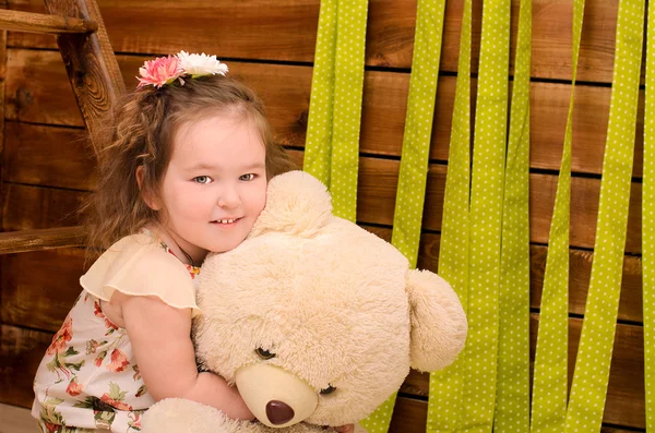 Little girl with big teddy bear