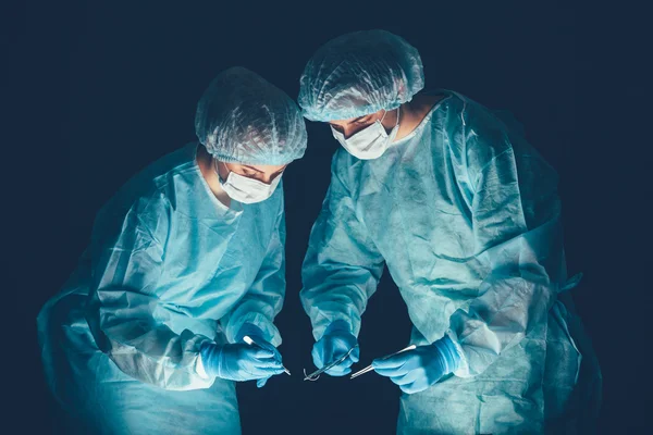 Medical team  hospital performing operation. Group of surgeon at work in operating theatre room. healthcare .