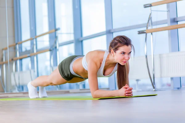 Training fitness woman doing plank core exercise working out for back spine and posture Concept pilates sport